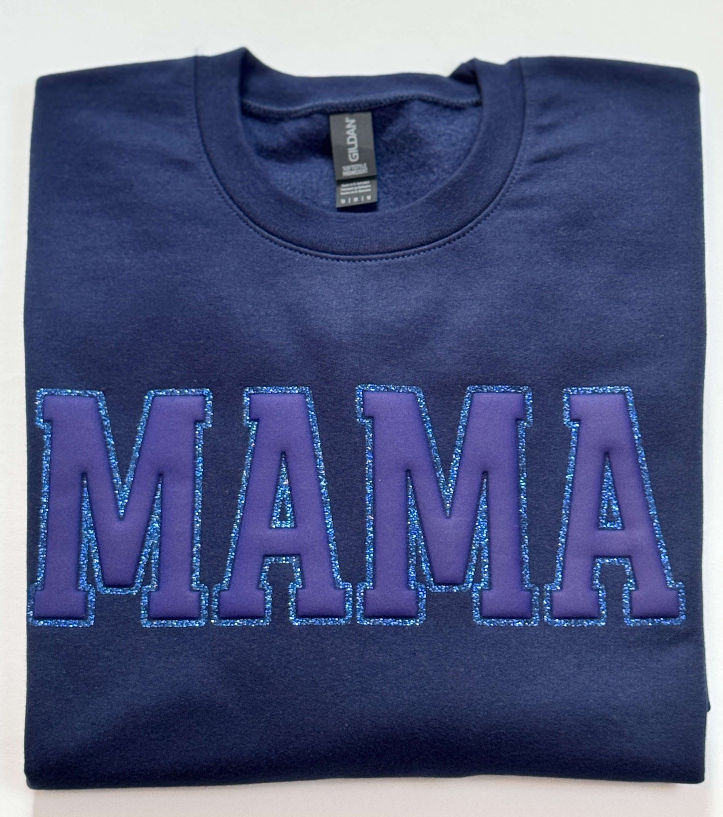 Gildan Softstyle Sweatshirt in Navy with a MAMA design in Navy Puff and outlined with blue glitter HTV for a tone-on-tone look and 3D effect.