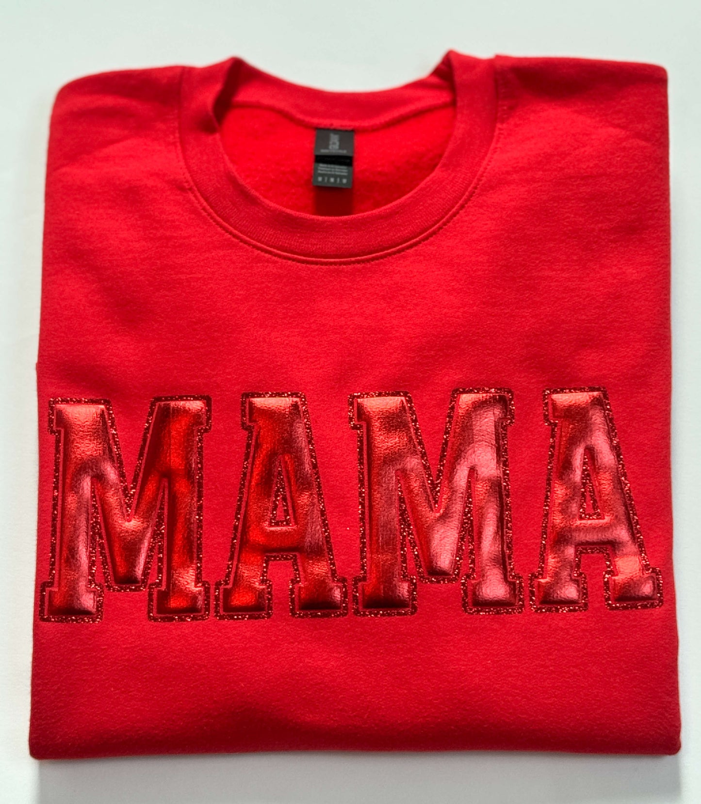 Gildan Softstyle Sweatshirt in Red with a MAMA design in Red Metallic Puff and outlined with red glitter HTV for a tone-on-tone look and 3D effect.
