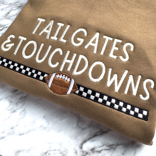 Close up of embroidered Bella Canvas 3945 football sweatshirt in Vintage Brown with Tailgates & Touchdowns design with racing stripe and football underneath.