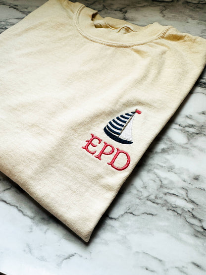 Close-up of the embroidered sailboat on a Comfort Colors t-shirt, showcasing premium embroidery detail and personalized with your initials.