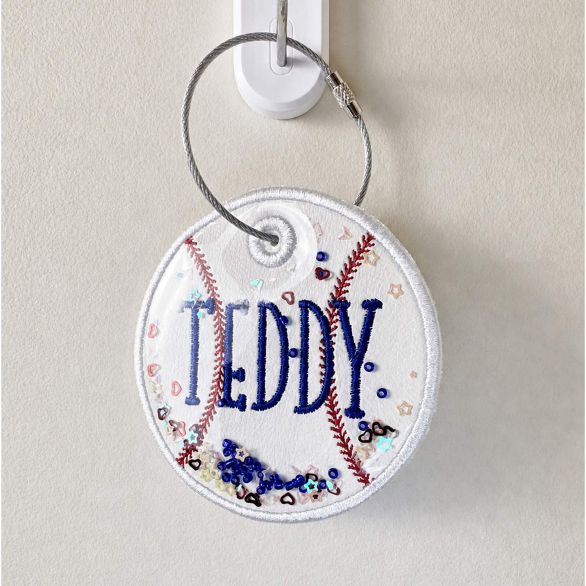 Personalized embroidered baseball bag tag on a stainless steel twist closure ring.  Can be personalized with name and jersey number.  Can also add matching ribbons.