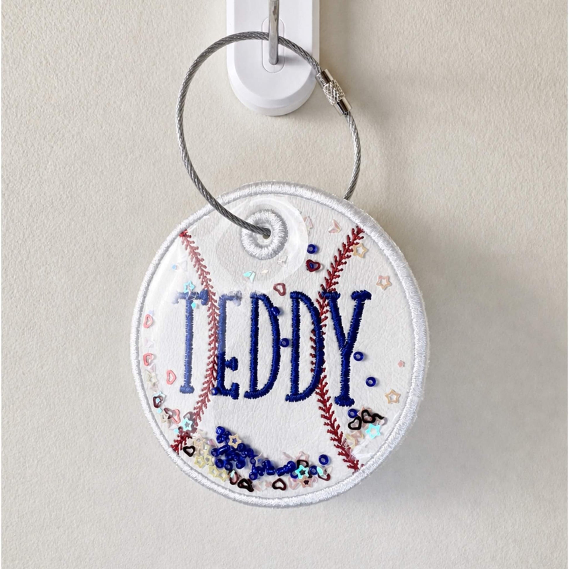 Personalized embroidered baseball bag tag on a stainless steel twist closure ring.  Can be personalized with name and jersey number.  Can also add matching ribbons.