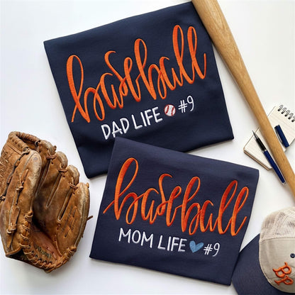 Collage of two embroidered Gildan Navy blue T-shirts.  One is for the baseball moms out there and the other one is for all the die hard baseball dads.  One design reads:  Baseball Mom Life with a cute heart, while the other shirt says Baseball Dad Life with a cute baseball.  You have the option to pick your shirt color, add a jersey number and pick a thread color for the word baseball to coordinate with your team's colors.
