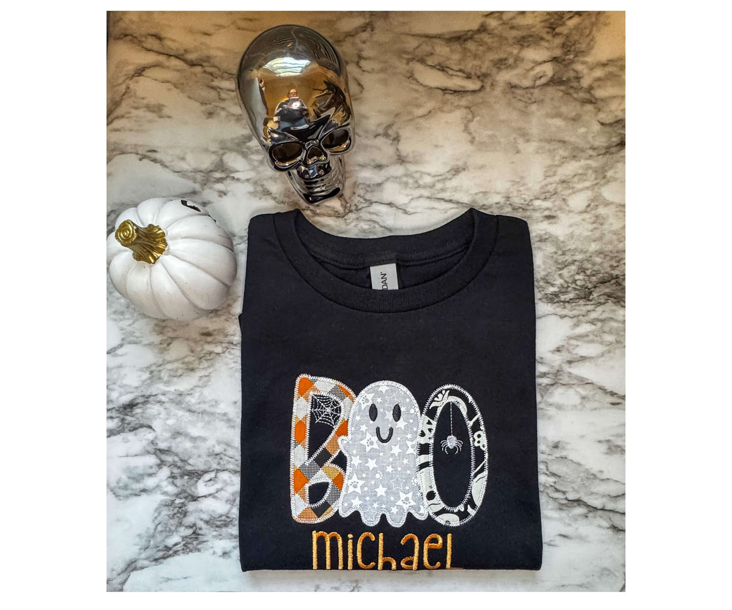 Black Gildan Personalized Halloween T-Shirt with the word "BOO"  embroidered on it with a cute ghost replacing one of the "O"s in the design.  Name of child embroidered underneath the design. 