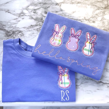 Kid's Gildan Embroidered T-Shirt in the color Violet with a cute applique bunny on the left chest, featuring a delicate lace border and coquette bow and spring colored fabrics.  The shirt can be personalized by adding your child's initials underneath the bunny.  Also featured is an adult verson of this design, except it has three applique bunnies with the words "hello spring" in a script embroidered font.  The adult version is listed separately.