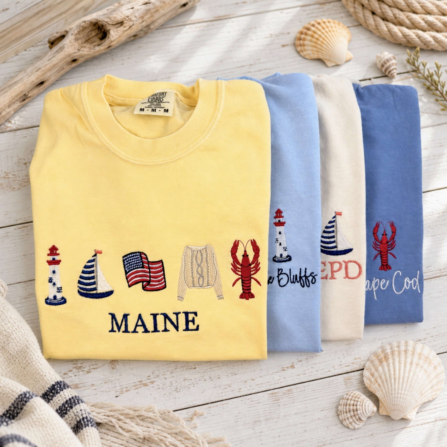 Full Coastal Collection of embroidered Comfort Colors tees featuring timeless seaside designs inspired by coastal living.  Part of the Coastal Collection.