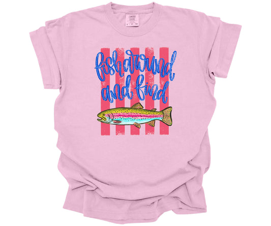 Hand-drawn trout fish graphic with hot pink horizontal lines and script text saying: "Fish Around and Find Trout" on a premium Comfort Colors T-shirt in the color Blossom.
