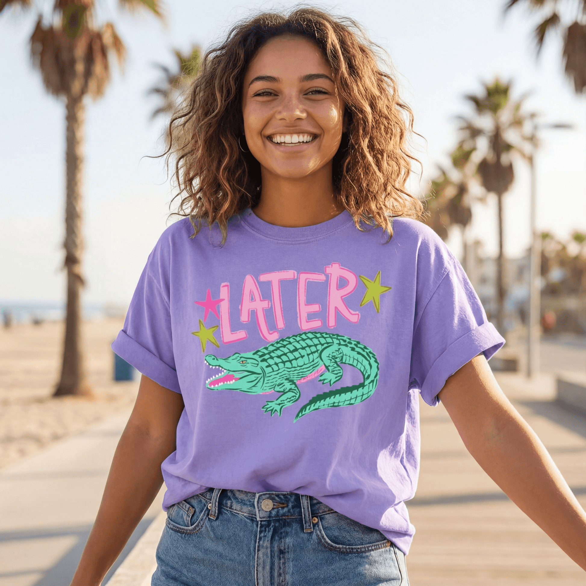 Image of a model wearing the Later Alligator comfort colors tee in the color violet.
