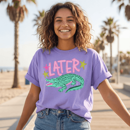 Image of a model wearing the Later Alligator comfort colors tee in the color violet.