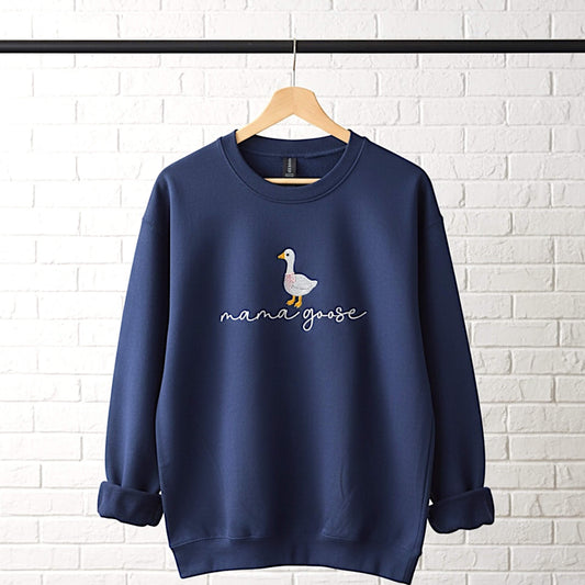 Gildan Softstyle Navy Sweatshirt with an embroiderered design of a cute goose with a pink bow around its neck and the words "mama goose" in a script font.