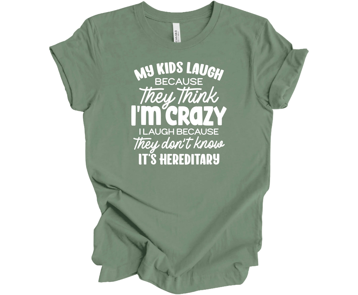 Bella Canvas T-Shirt in Sage with the funny saying "My Kids Laugh because they think I'm Crazy I laugh because they don't know its hereditary"