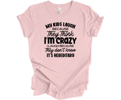 Bella Canvas T-Shirt in Soft Pink with the funny saying "My Kids Laugh because they think I'm Crazy I laugh because they don't know its hereditary"