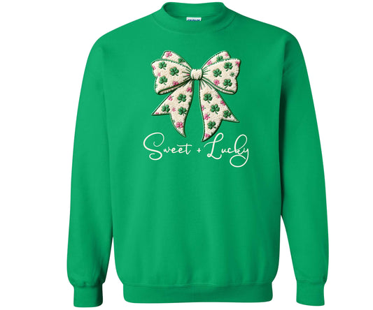 Gildan Heavy Blend Sweatshirt in the color Irish Green with the cutest faux yarn bow design.   The bow is St. Patrick's Day themed - it is off-white with bright green and pink shamrocks all over it.  The words Sweet + Lucky are in a script font underneath the bow.   A very festive sweatshirt for St. Patrick's Day.