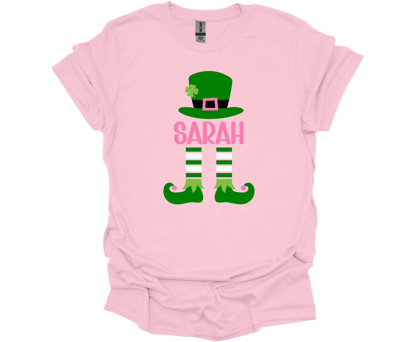 Gildan Softstyle T-Shirt in Light Pink with a St. Patrick's Day Elf design that can be personalized with your name.