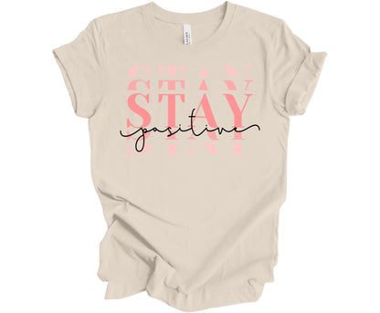 Bella Canvas T-Shirt in Dust with the word Stay (Stacked) and the word Positive across it.