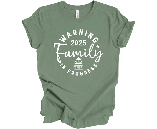 Bella Canvas T-shirt in Sage with the saying Warning Family Trip in Progress 2025