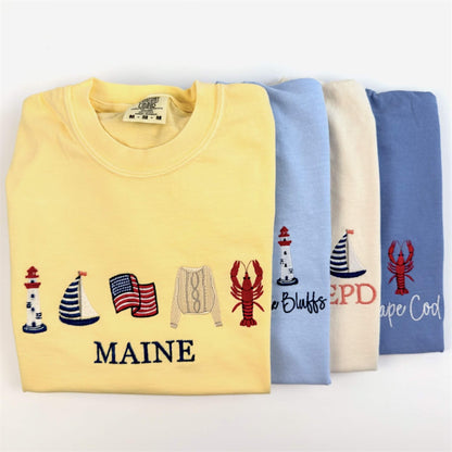 Full Coastal Collection of embroidered Comfort Colors tees featuring timeless seaside designs inspired by coastal living.  Part of the Coastal Collection.