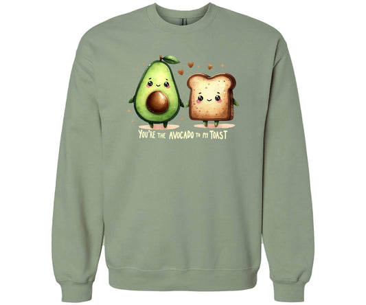 Gildan Softstyle Sweatshirt in the color Sage with a cute graphic of an Avocado and a piece of Toast and the words "You're the Avocado to my Toast".